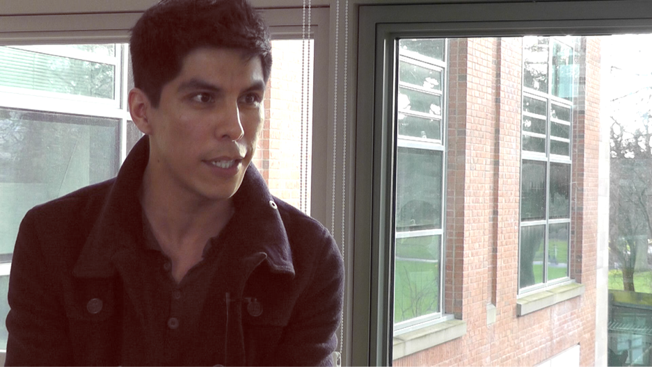 Student standing beside a window