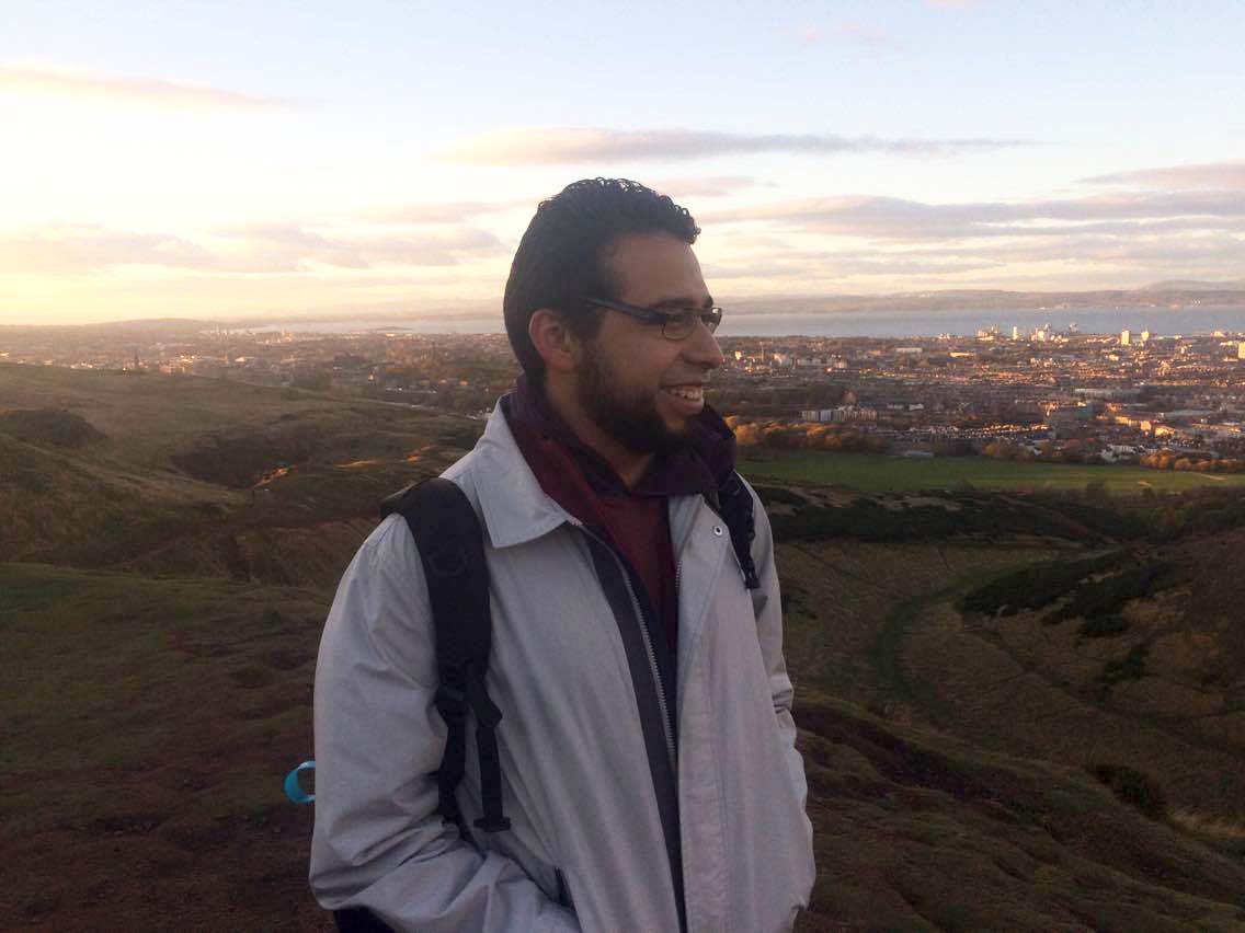 Student in a field during sunset